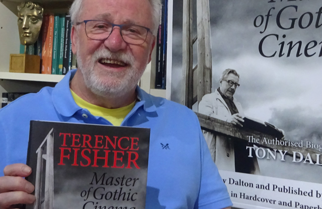 A close-up image of Tony Dalton, holding up &#039;Terence Fisher, Master of Gothic Cinema&#039; book.