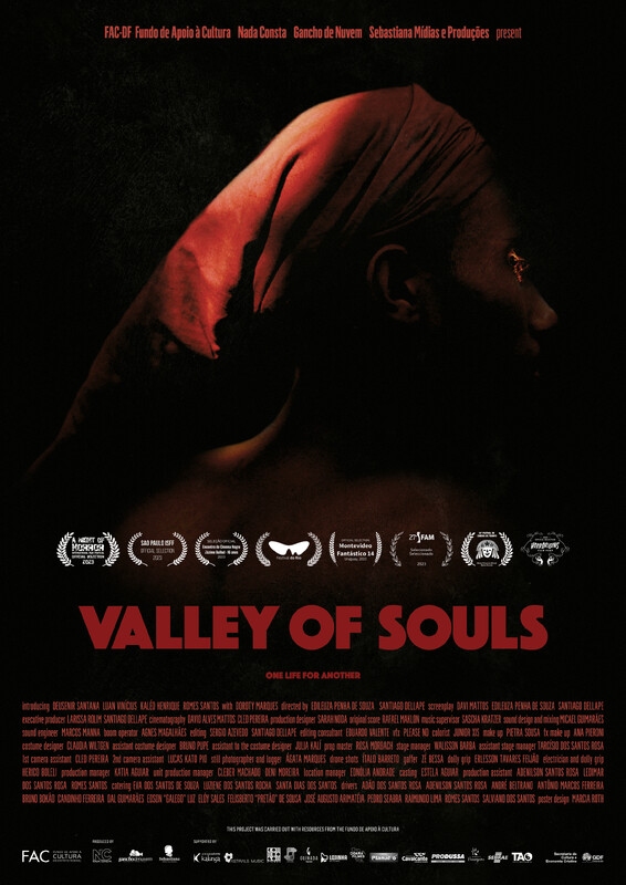A poster for the film Valley of Souls, showing a a Black woman wearing a head scarf and looking to the right, her eyes seemingly glowing.