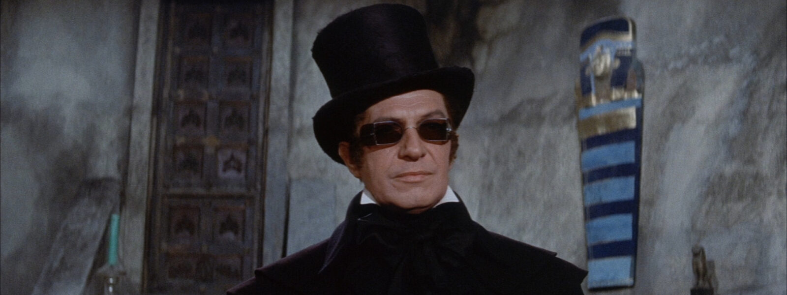 Vincent Price wearing sunglasses and a top hat
