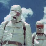 Two men with white breathing gear stare down.