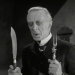 A man holding knives and fork