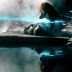 A man lies under a blue laser light